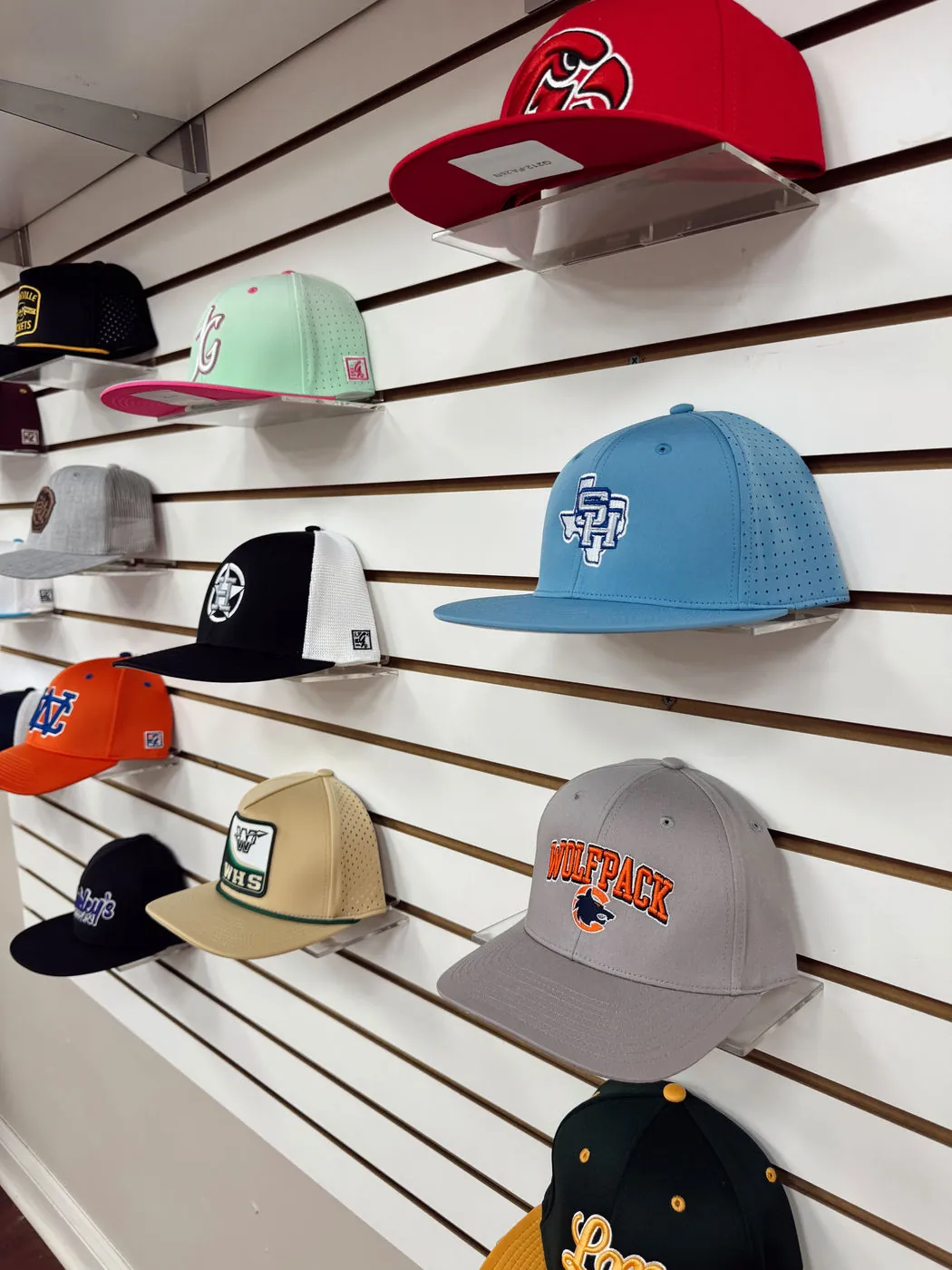 More embroidered caps in team colors on the display wall