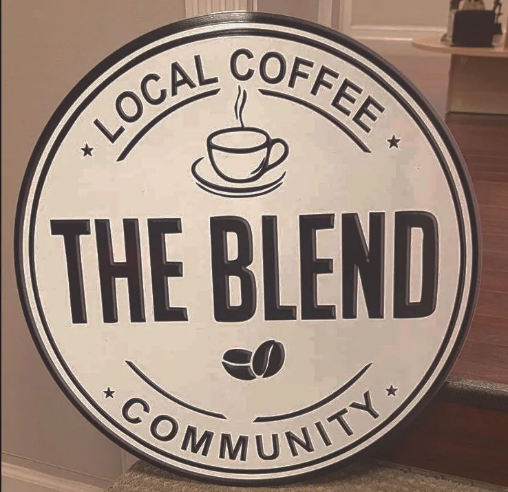 Carved and painted round sign for a local coffee shop